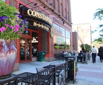 the outside of a restaurant with tables and chairs